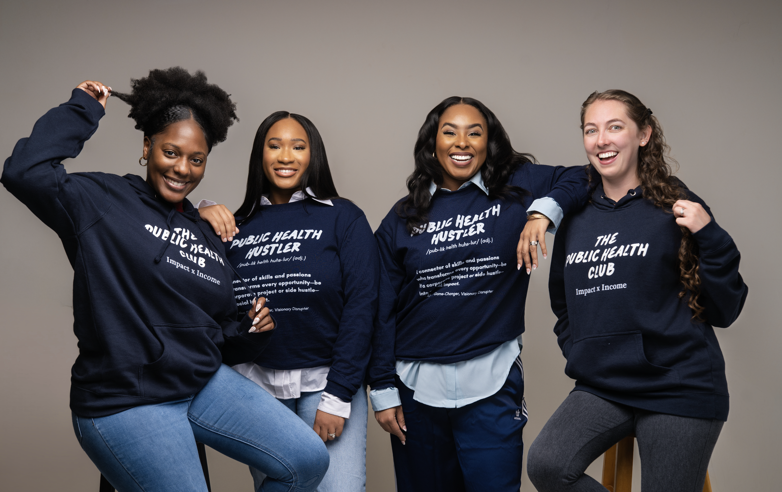 Four PHC members wearing The Public Health Club and Public Health Hustler sweatshirts.